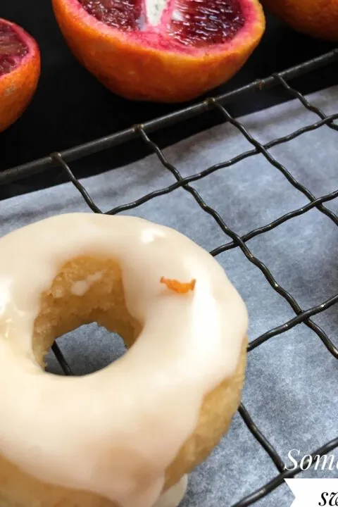Mini baked vanilla donuts with blood orange glaze